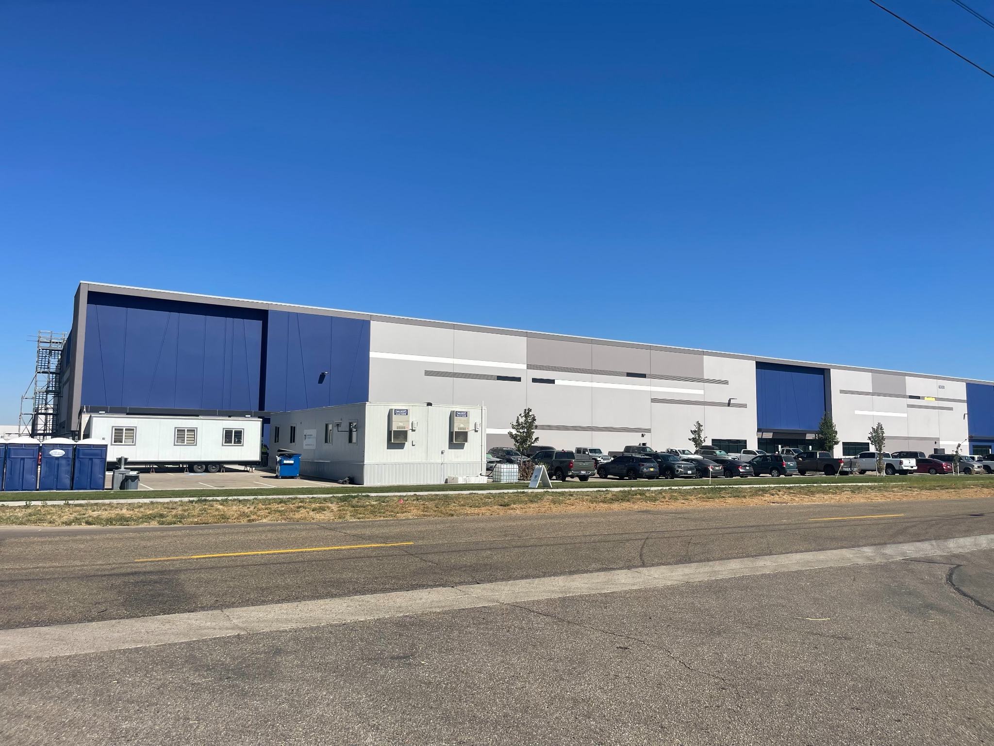Blue and gray industrial building at 8300 Birch Lane in Nampa with construction trailers outside